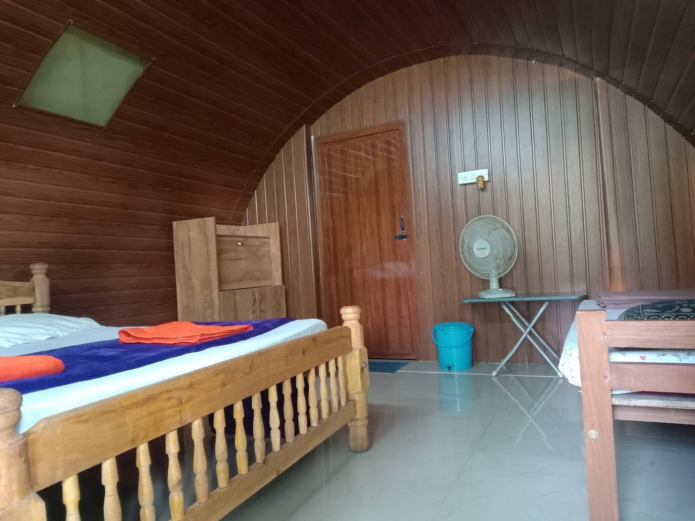Wooden Cottage interior with a curved wooden ceiling and bed